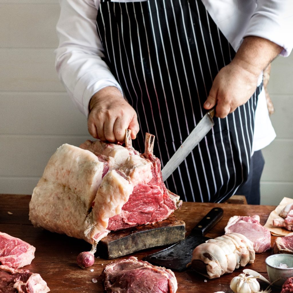 Butcher Cutting Steak in Butcher Shop