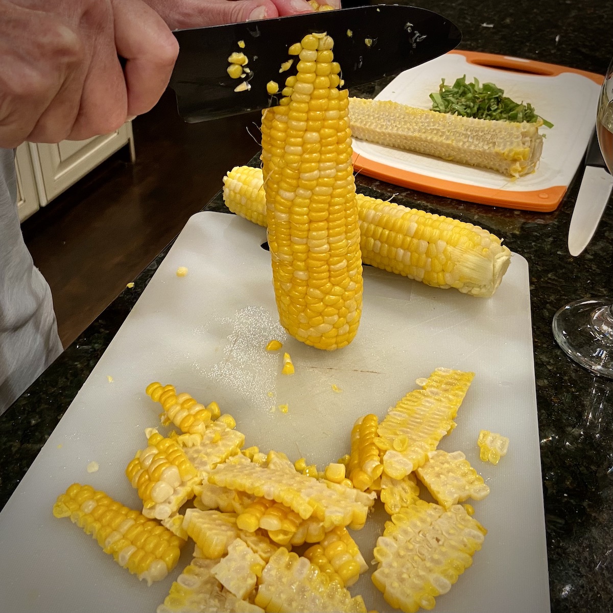 Cutting fresh corn off cob